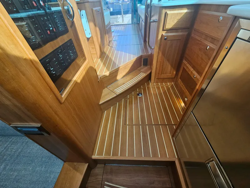 Slide: The Image of Interior of 2023 Sabre 43 Salon Express with wooden cabinetry and flooring. - 42