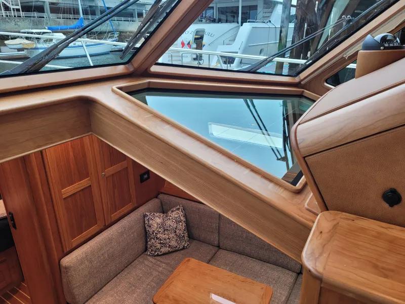 Slide: The Image of Interior of 2023 Sabre 43 Salon Express yacht, featuring elegant wood finish and cozy seating area. - 43