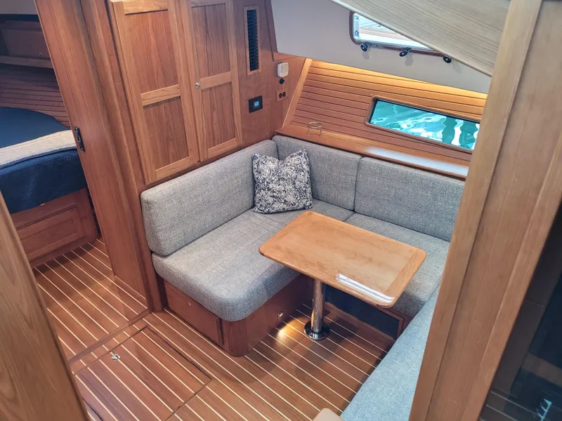 Slide: The Image of 2023 Sabre 43 Salon Express interior with cozy seating and wooden accents. - 46