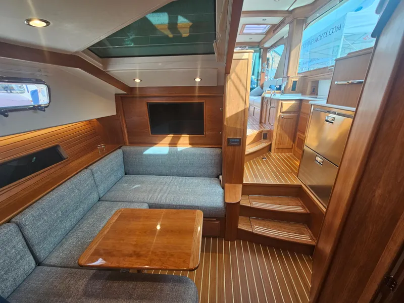 Slide: The Image of Interior of 2023 Sabre 43 Salon Express yacht with wood finish and cozy seating area. - 47