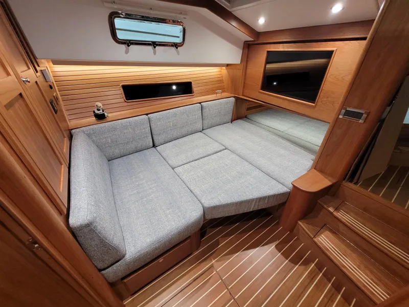 Slide: The Image of Interior of 2023 Sabre 43 Salon Express with modern gray seating and wooden accents. - 49