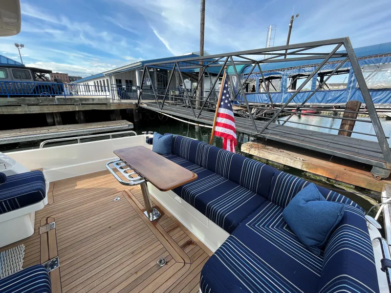 Slide: The Image of 2023 Sabre 43 Salon Express yacht with elegant deck seating and American flag. - 92