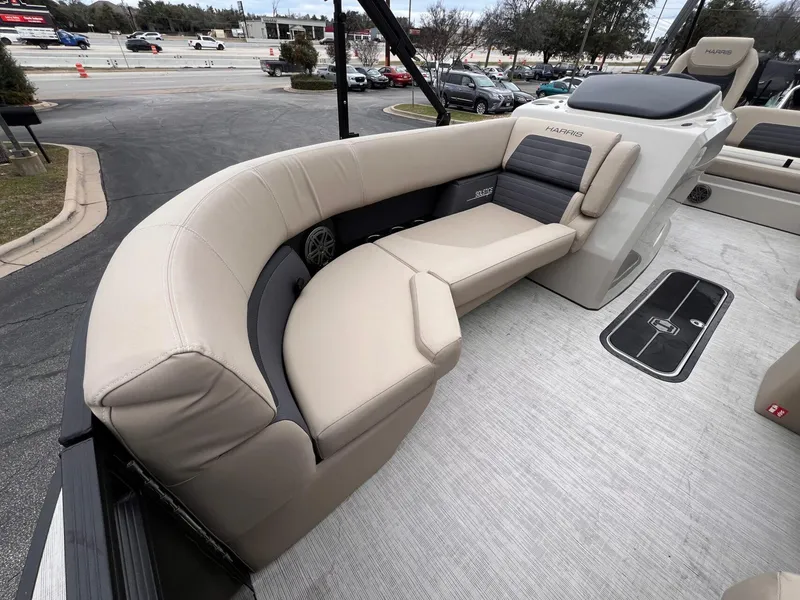 Slide: The Image of 2025 Harris Solstice 230 boat interior with beige seating and modern design. - 13
