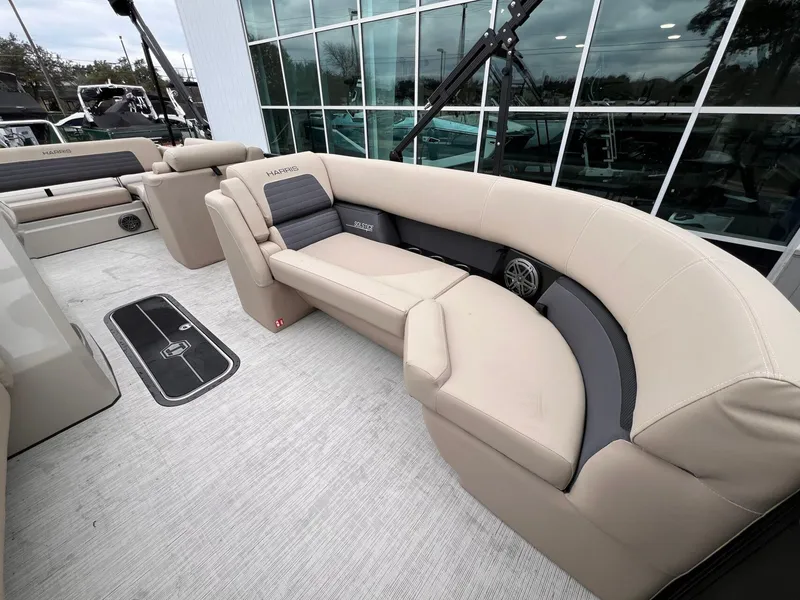 Slide: The Image of 2025 Harris Solstice 230 boat interior with beige seating and modern design. - 14