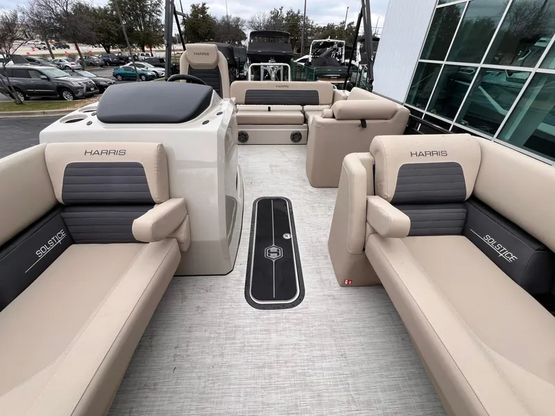 Slide: The Image of 2025 Harris Solstice 230 boat interior with beige seating and modern design. - 16