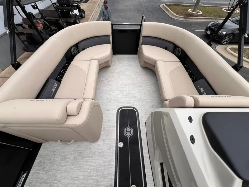 Slide: The Image of 2025 Harris Solstice 230 boat interior with beige seating and modern design. - 17