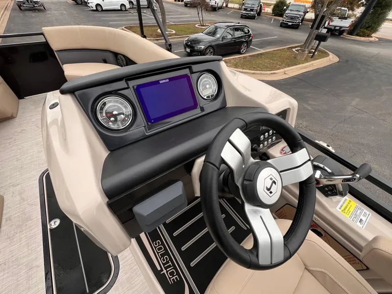 Slide: The Image of 2025 Harris Solstice 230 boat dashboard with steering wheel and digital display. - 19