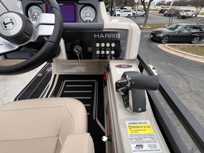 Slide: The Image of 2025 Harris Solstice 230 boat dashboard with steering wheel and control panel. - 21