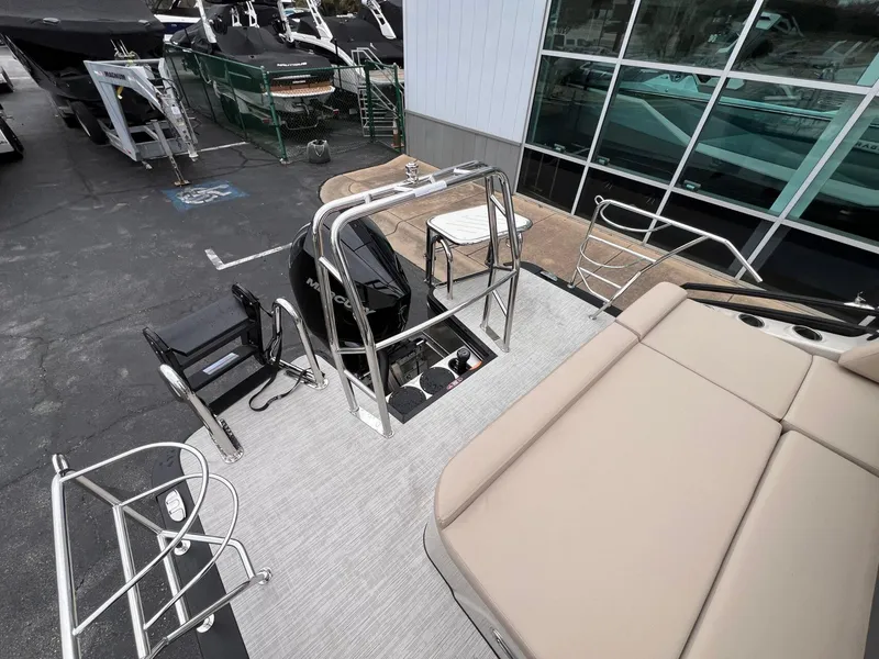 Slide: The Image of 2025 Harris Solstice 230 pontoon boat with Mercury engine, docked at marina. - 27