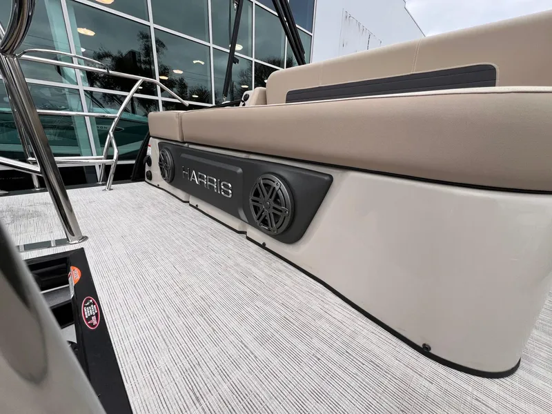Slide: The Image of 2025 Harris Solstice 230 boat interior with beige seating and speaker system. - 28