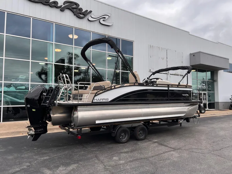 Slide: The Image of 2025 Harris Solstice 230 pontoon boat on trailer outside dealership. - 3