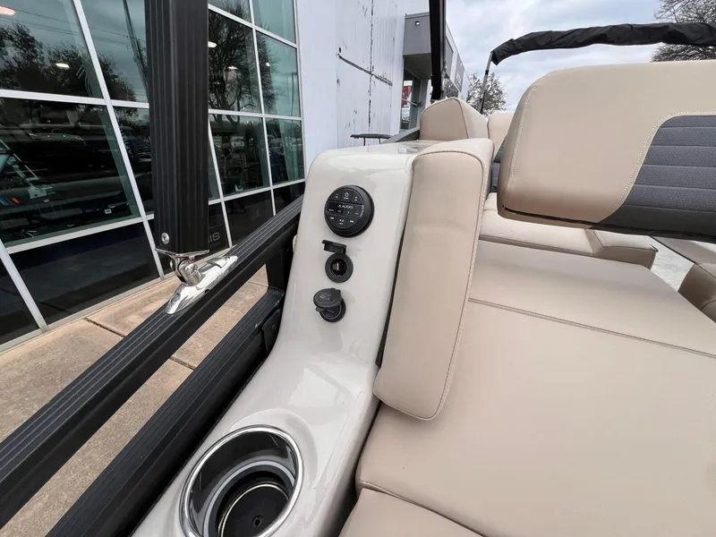 Slide: The Image of 2025 Harris Solstice 230 boat interior with beige seating and control panel. - 31