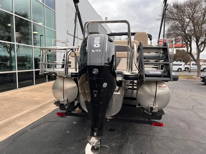 Slide: The Image of 2025 Harris Solstice 230 pontoon boat with powerful 250 V8 engine, parked outside dealership. - 4