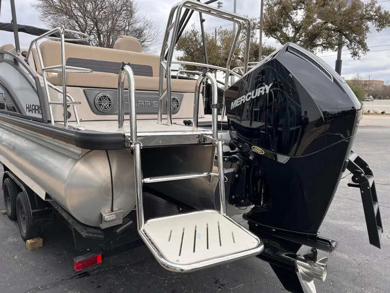 Slide: The Image of 2025 Harris Solstice 230 pontoon boat with Mercury outboard motor, rear view. - 7