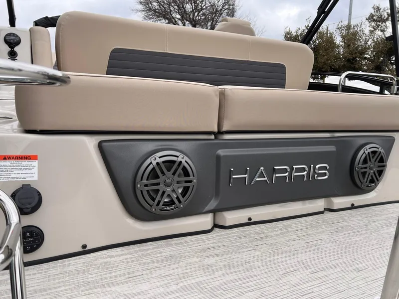 Slide: The Image of 2025 Harris Solstice 230 boat interior with speakers and seating. - 8
