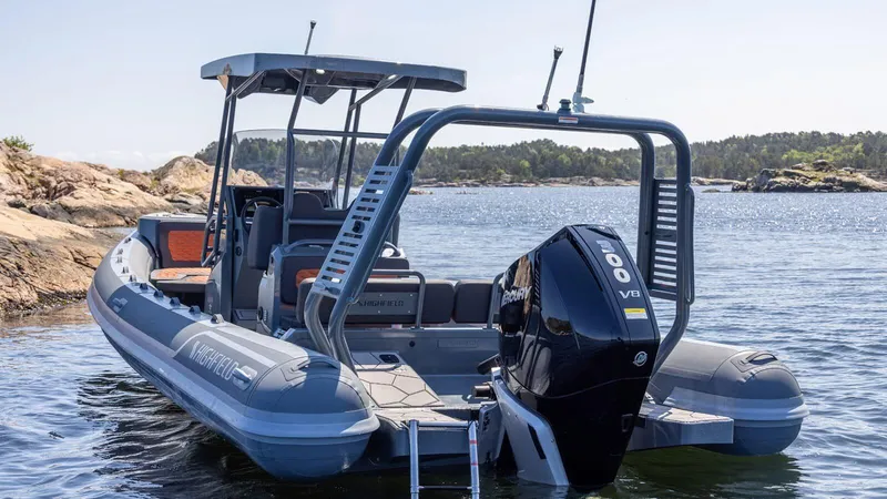 The Image of 2025 Highfield Sport 760 boat with powerful outboard motor on scenic water. - 0