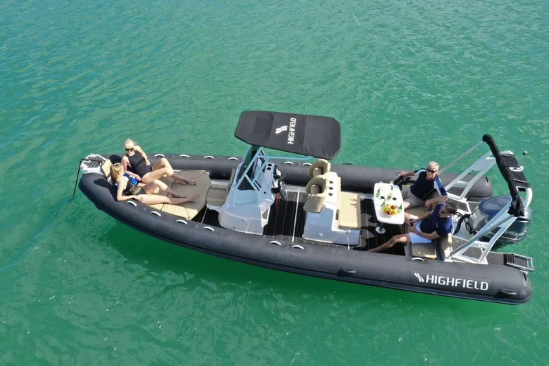 Slide: The Image of Highfield Sport 760 boat, 2025 model, cruising on clear turquoise water with passengers. - 4