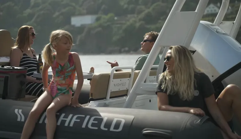 Slide: The Image of Family enjoying a day on a 2025 Highfield Sport 760 boat. - 6