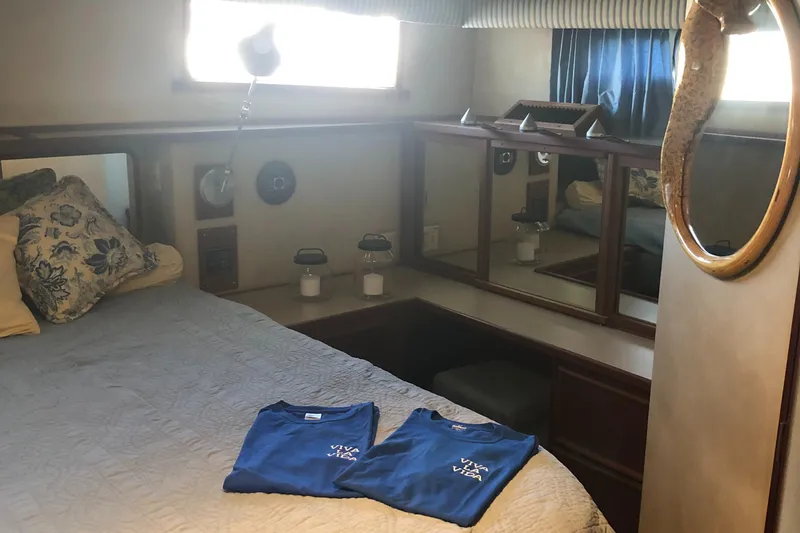 Slide: The Image of Interior of 1987 Chris-Craft 426 Catalina yacht with cozy bedroom and nautical decor. - 13