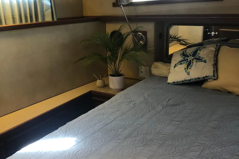 Slide: The Image of Cozy bedroom interior of 1987 Chris-Craft 426 Catalina yacht with plant decor. - 14