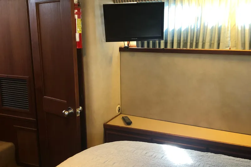 Slide: The Image of 1987 Chris-Craft 426 Catalina cabin interior with TV and wooden furnishings. - 15