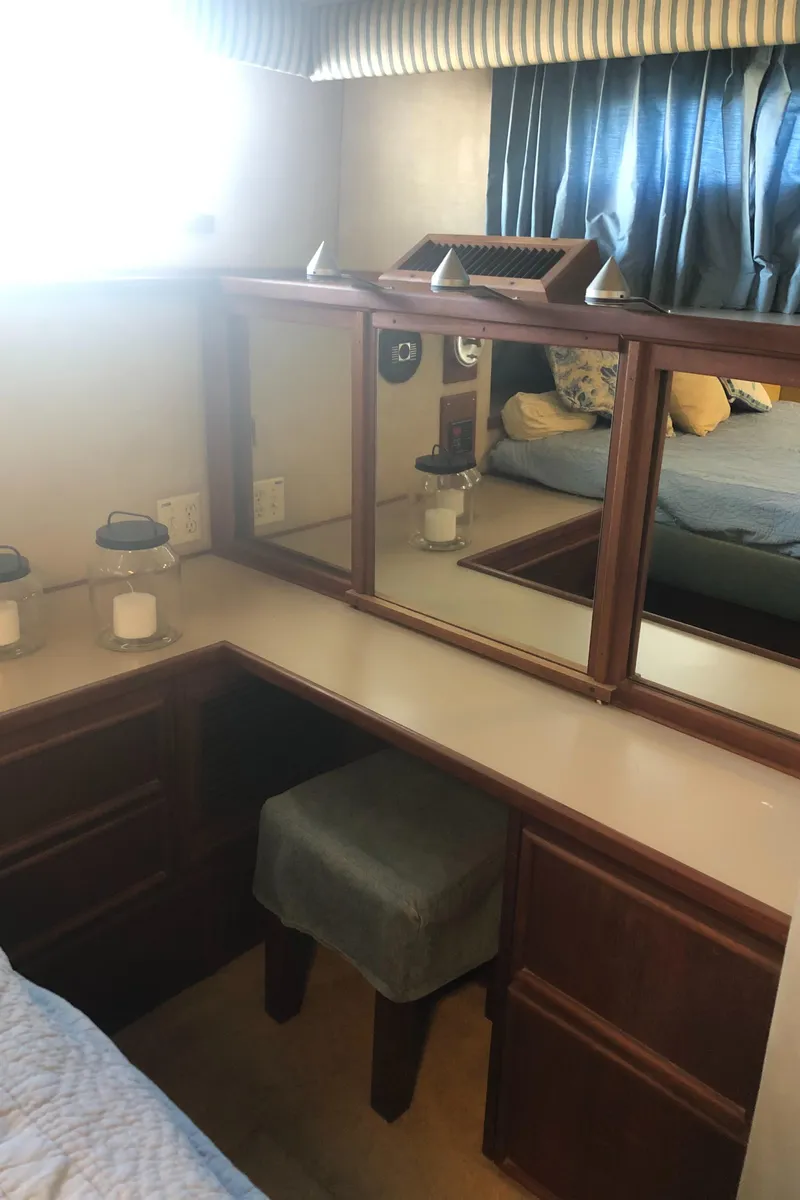 Slide: The Image of 1987 Chris-Craft 426 Catalina cabin with vanity, mirrors, and seating. - 16
