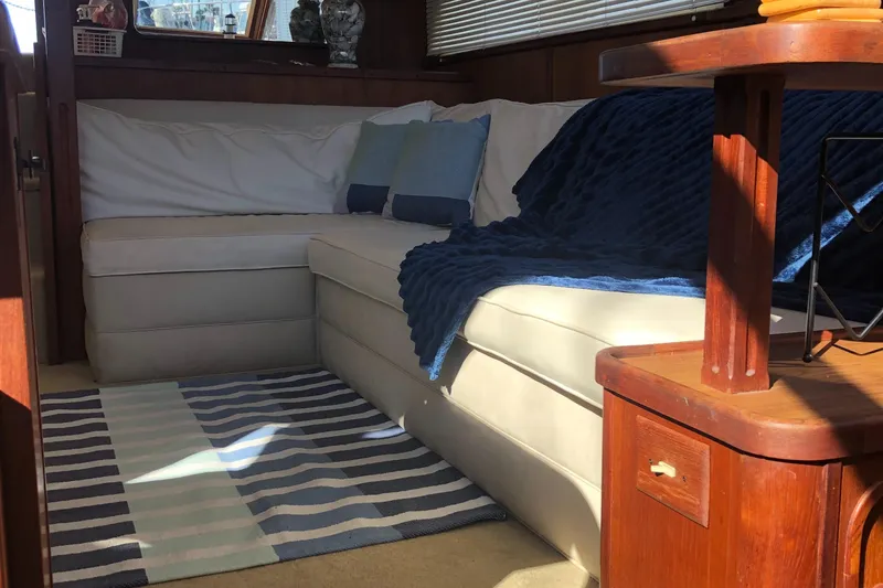 Slide: The Image of Interior of 1987 Chris-Craft 426 Catalina with cozy seating and nautical decor. - 17