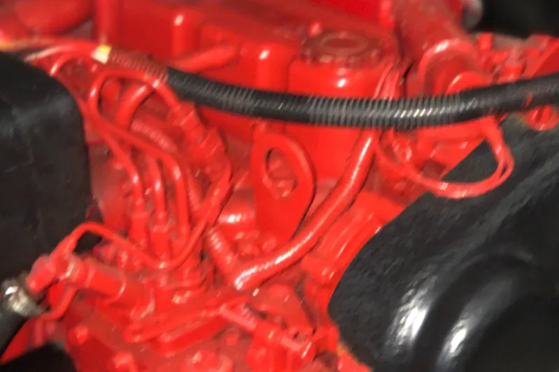 Slide: The Image of Close-up of a red engine in a 1987 Chris-Craft 426 Catalina boat. - 25