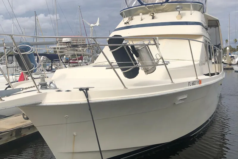 Slide: The Image of 1987 Chris-Craft 426 Catalina yacht docked in marina, featuring sleek design and spacious deck. - 3