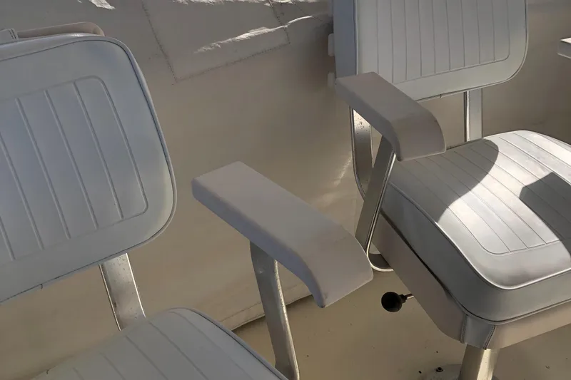 Slide: The Image of White seating on 1987 Chris-Craft 426 Catalina boat, featuring sleek armrests and cushions. - 30