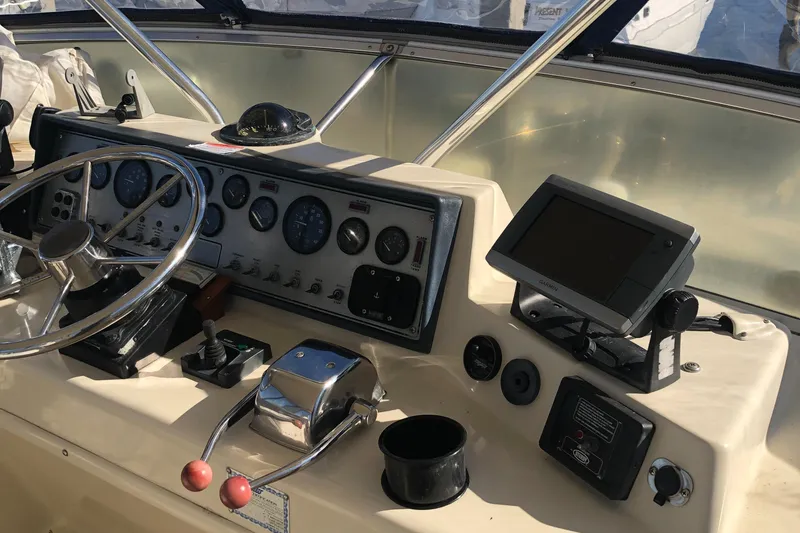 Slide: The Image of 1987 Chris-Craft 426 Catalina helm with steering wheel, gauges, and navigation equipment. - 32