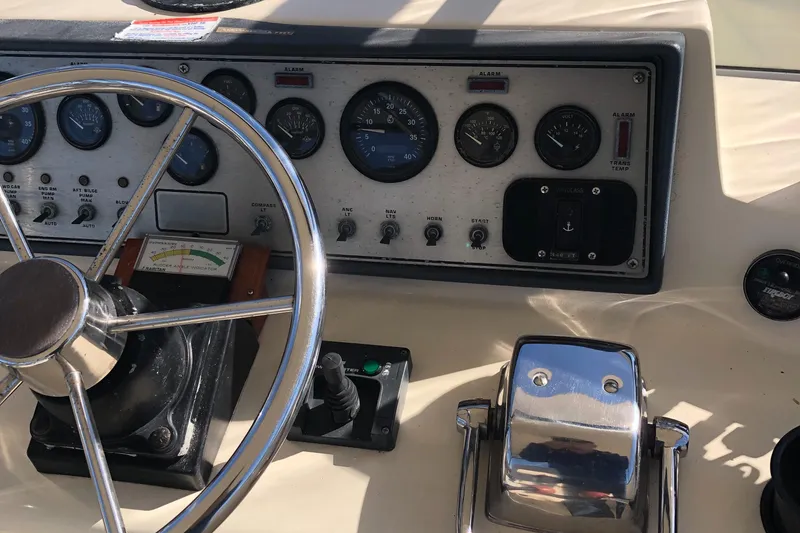 Slide: The Image of Dashboard of 1987 Chris-Craft 426 Catalina boat with steering wheel and control panel. - 33