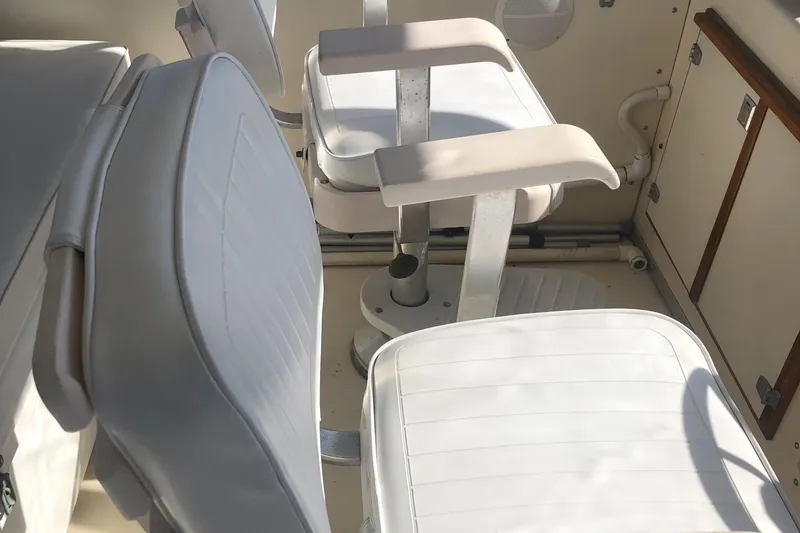 Slide: The Image of 1987 Chris-Craft 426 Catalina interior with white cushioned seating and armrests. - 36