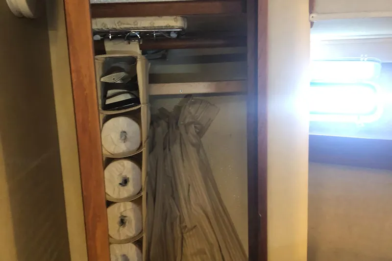 Slide: The Image of Closet interior on 1987 Chris-Craft 426 Catalina, featuring storage shelves and hanging space. - 39