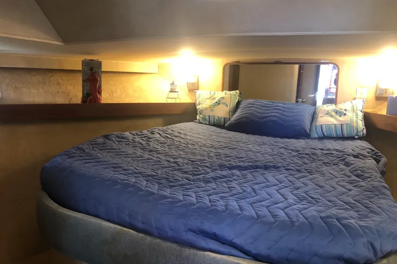 Slide: The Image of 1987 Chris-Craft 426 Catalina cabin interior with cozy bed and ambient lighting. - 4