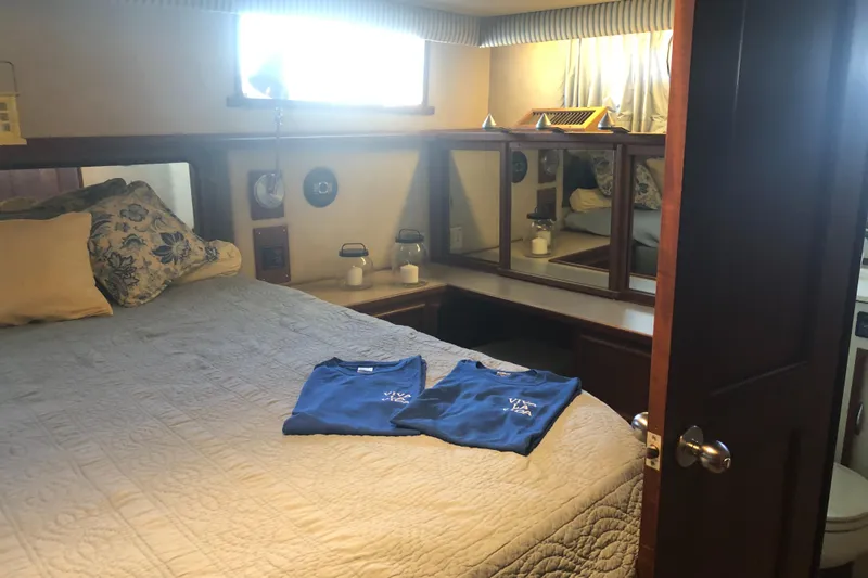 Slide: The Image of Cozy bedroom interior of 1987 Chris-Craft 426 Catalina yacht with bed and mirrors. - 41
