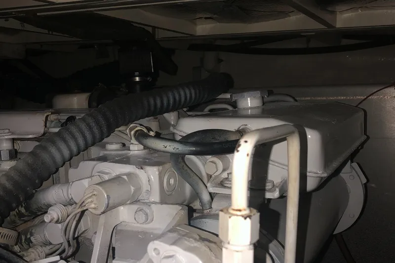 Slide: The Image of Engine compartment of 1987 Chris-Craft 426 Catalina with visible hoses and components. - 47