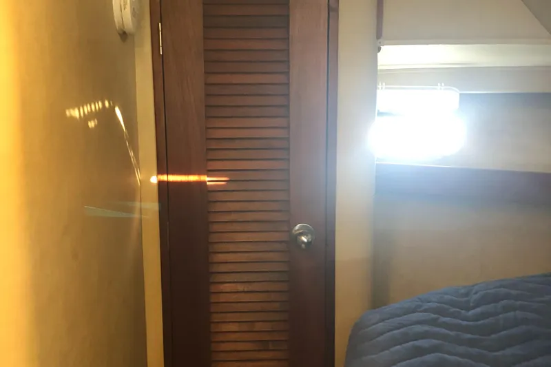 Slide: The Image of Interior of 1987 Chris-Craft 426 Catalina with wooden door and bed. - 5