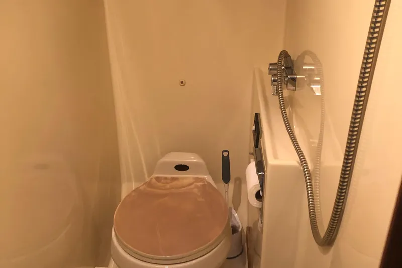 Slide: The Image of 1987 Chris-Craft 426 Catalina bathroom with toilet and shower fixtures. - 7