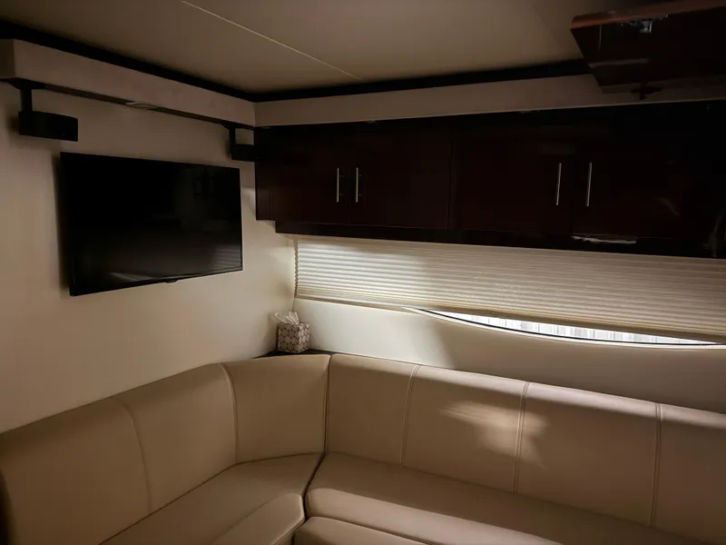 Slide: The Image of Interior of 2015 Regal 42 Sport Coupe with beige seating and wall-mounted TV. - 13