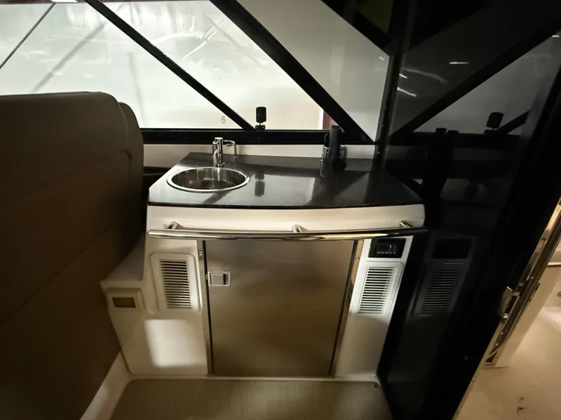 Slide: The Image of Interior of 2015 Regal 42 Sport Coupe with compact kitchenette and stainless steel sink. - 14