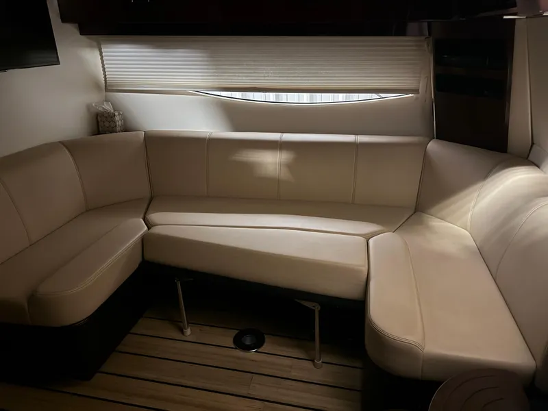 Slide: The Image of Interior of 2015 Regal 42 Sport Coupe with beige leather seating and wooden flooring. - 26