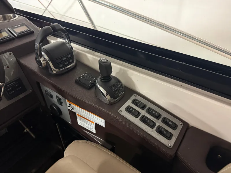 Slide: The Image of Control panel of a 2015 Regal 42 Sport Coupe boat with joystick and switches. - 5