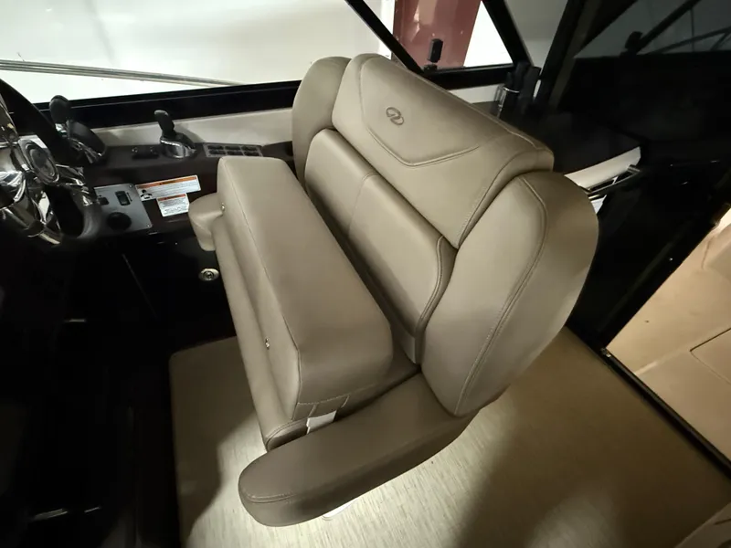 Slide: The Image of Captain's seat in 2015 Regal 42 Sport Coupe, featuring luxurious beige leather upholstery. - 7