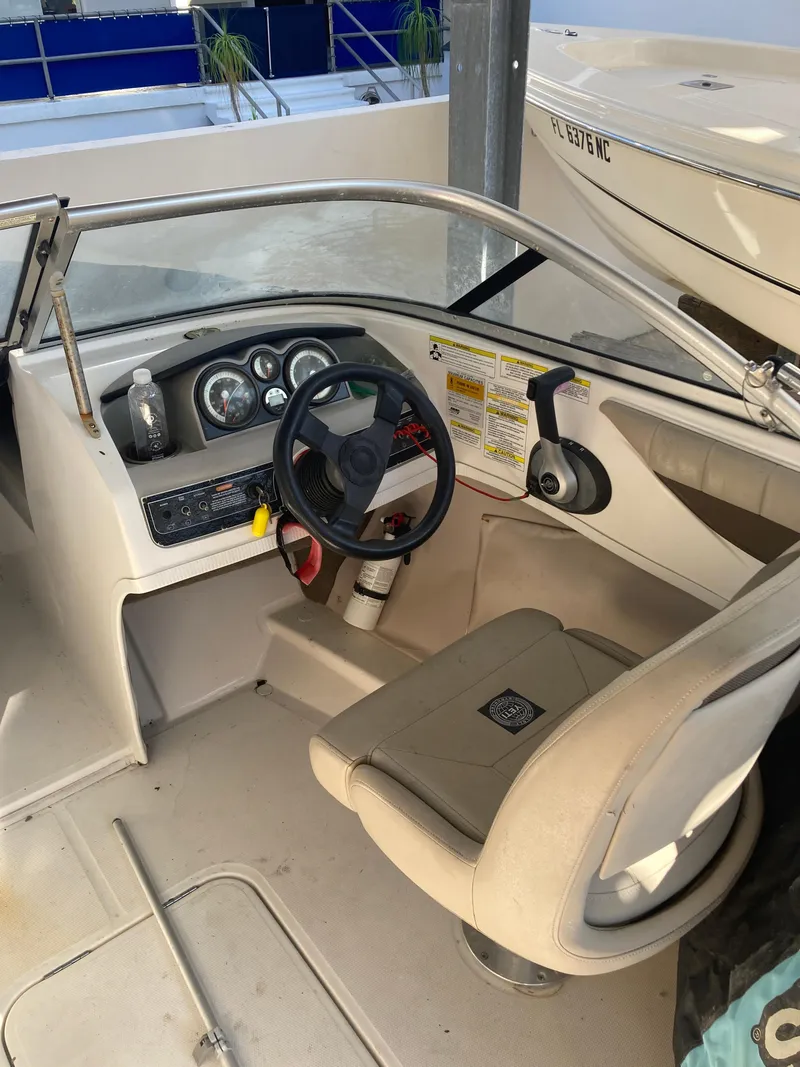 Slide: The Image of 2014 Bayliner 180 Bowrider cockpit with steering wheel and dashboard controls. - 6