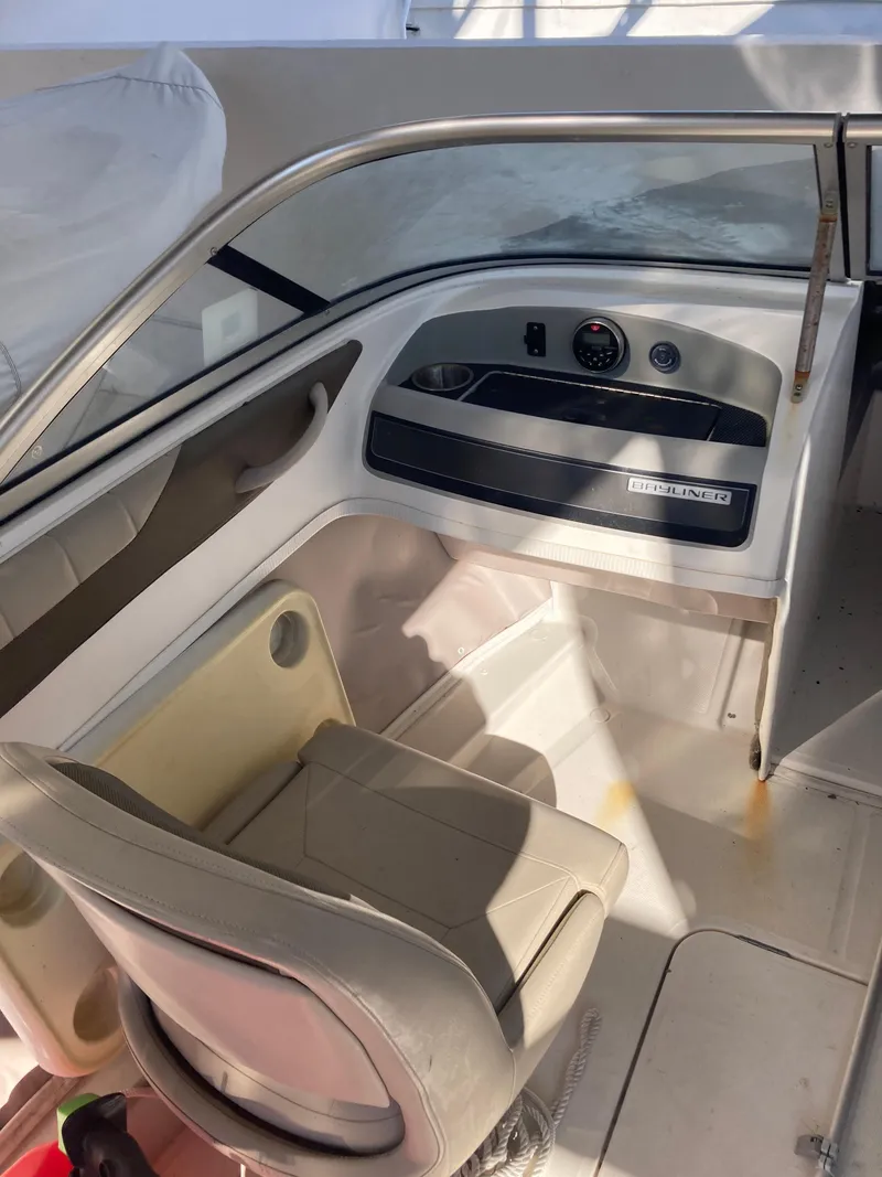 Slide: The Image of 2014 Bayliner 180 Bowrider cockpit with steering wheel and seating. - 7