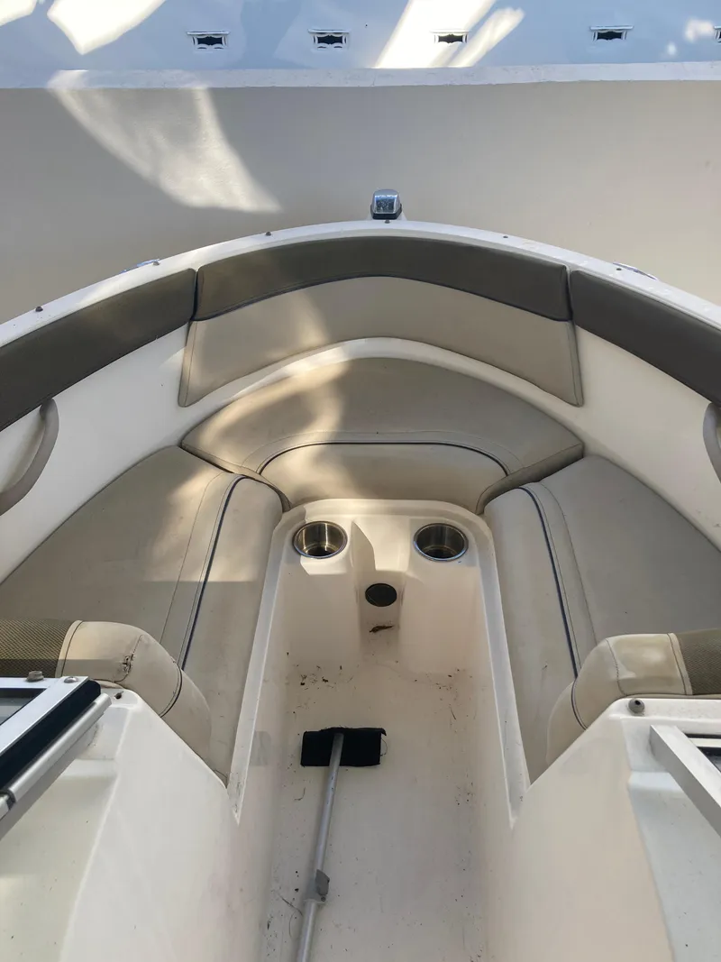 Slide: The Image of 2014 Bayliner 180 Bowrider interior with seating and cup holders. - 8