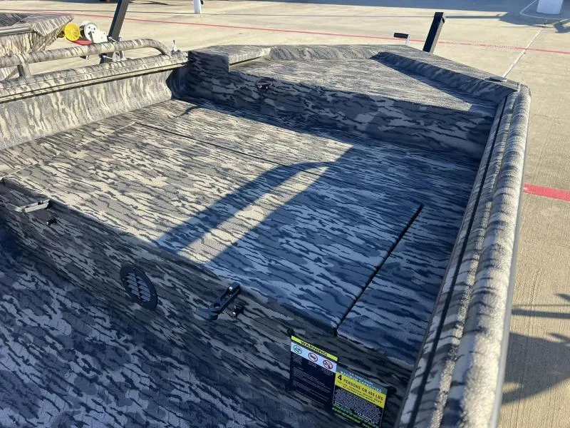 Slide: The Image of 2024 Havoc Boats 1756MSTC with camouflage interior design, parked on concrete surface. - 4