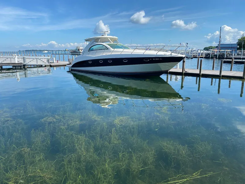 The Image of 2002 Maxum 4200 SCR yacht docked in clear, calm marina waters. - 0