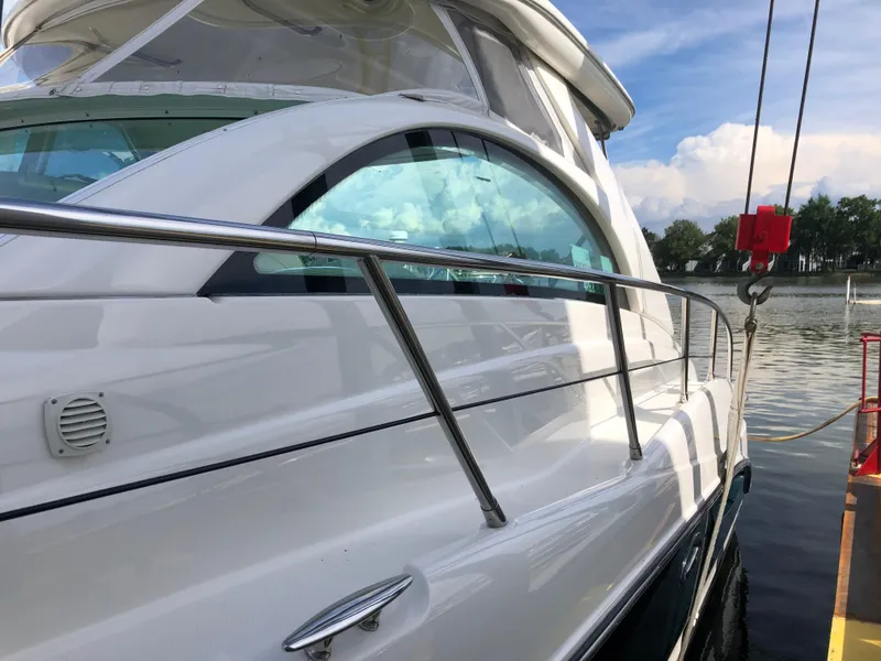 Slide: The Image of Maxum 4200 SCR 2002 yacht docked by the water on a sunny day. - 10